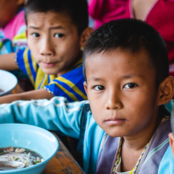 Global Reports of school meals around the world - Boys eating school meal lunch, school feeding